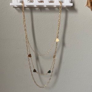 3 attached gold necklaces.